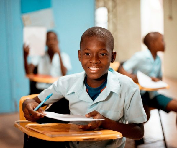 boy holding white paper