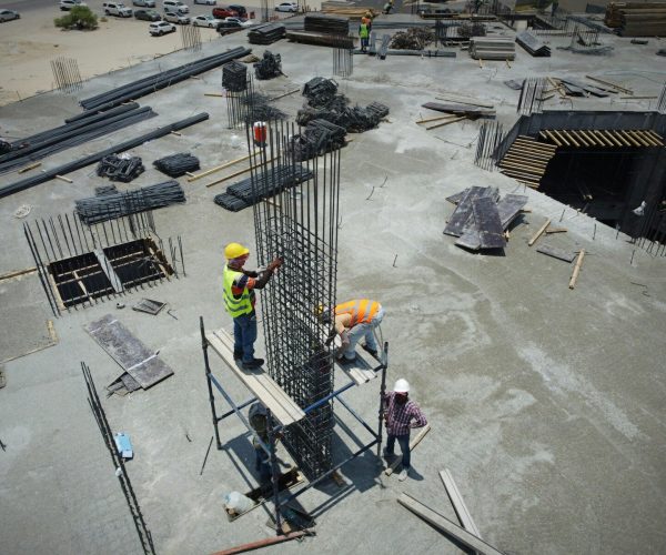 a group of men standing on top of a construction site