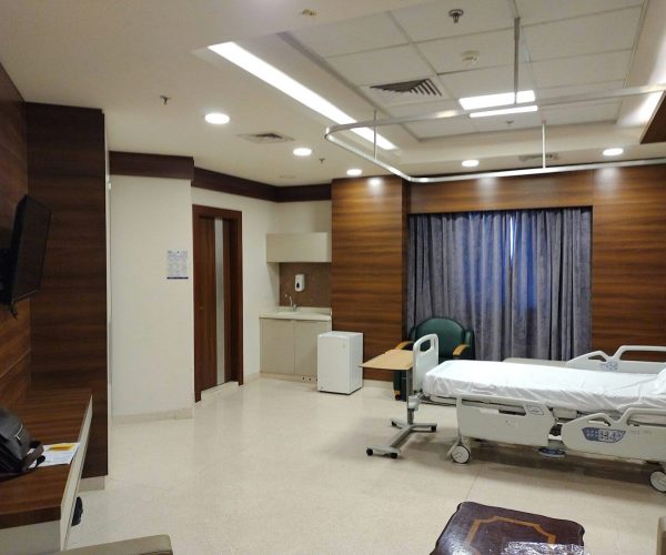 a hospital room with a bed and a television